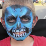 Boy with a blue skull design at the Friday Night Concerts in South Riding