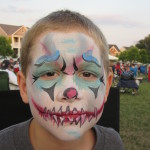 Two boys with an evil clown design at the Friday Night Concerts in South Riding